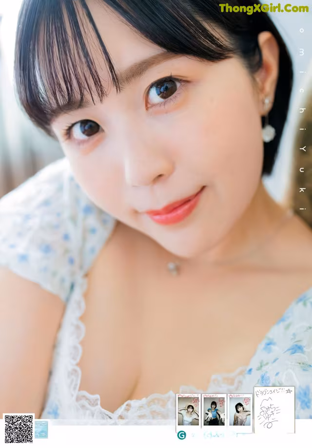 A woman in a white dress is posing for a picture.