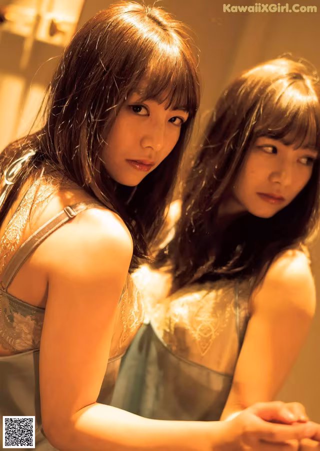 A couple of women standing next to each other in a bathroom.