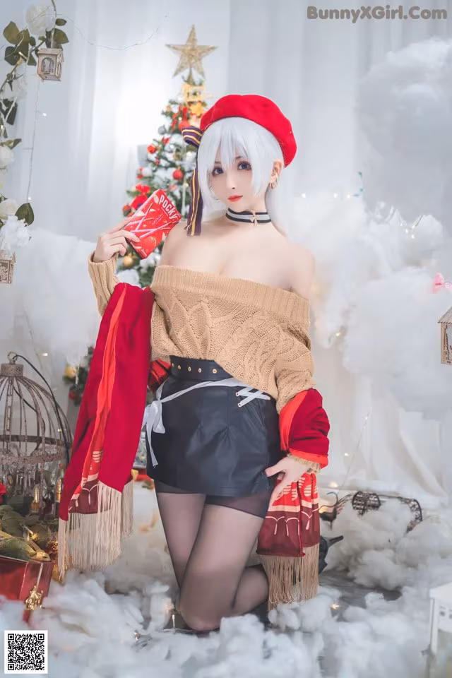 A woman in a red beret is posing in front of a Christmas tree.