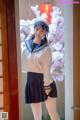A woman in a sailor outfit posing for a picture.
